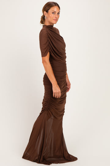 woman wearing a brown fitted evening gown with short sleeves and gathered draping details