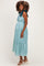 woman wearing a teal plaid maternity dress with tie straps and a visible baby bump