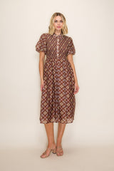 woman wearing a brown plaid midi dress with short puff sleeves and a button-down front