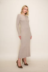 woman wearing a beige ribbed long sleeve midi dress with button details and high heels