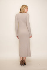 woman wearing a light beige ribbed long sleeve knit dress standing backwards with a fitted silhouette and midi length