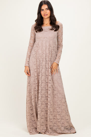 woman wearing a long sleeve beige lace maxi dress with a fitted bodice and flowing skirt
