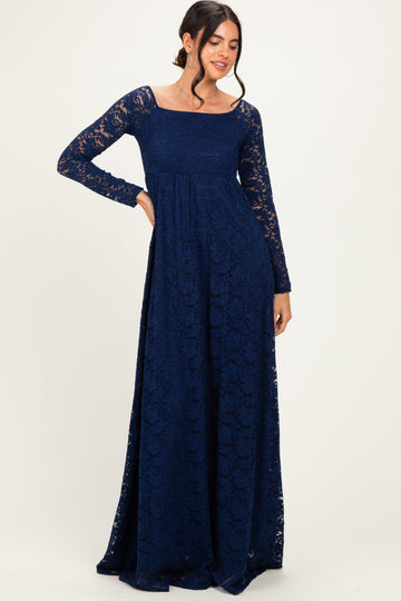 woman wearing a navy blue long sleeve lace maxi dress with a square neck and flowing skirt