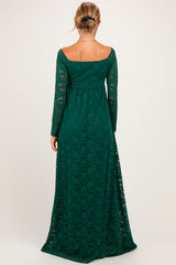 woman wearing a dark green long sleeve lace maternity dress, showing the back view with a flowing skirt