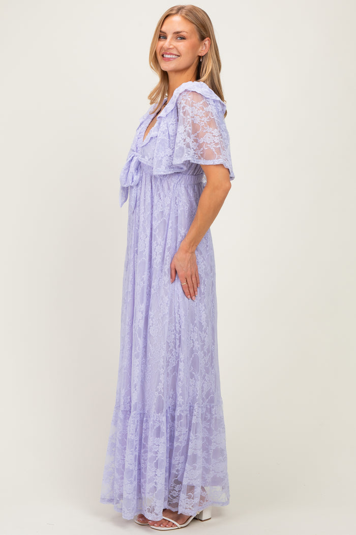 woman wearing a light purple lace maxi dress with short sleeves and a tie detail at the neckline