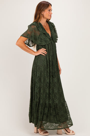 woman wearing a forest green lace maxi dress with flutter sleeves and a tiered skirt, standing in profile