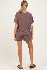woman wearing a brown short sleeve maternity loungewear set with shorts, showing a comfortable fit from the back