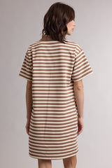 woman wearing a brown and white striped short sleeve dress viewed from the back