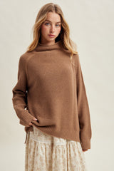 woman wearing a brown knit sweater with a high neckline paired with a floral print skirt