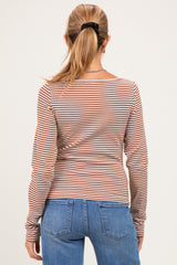 woman wearing a striped maternity long sleeve top with a fitted style, viewed from the back with blue jeans
