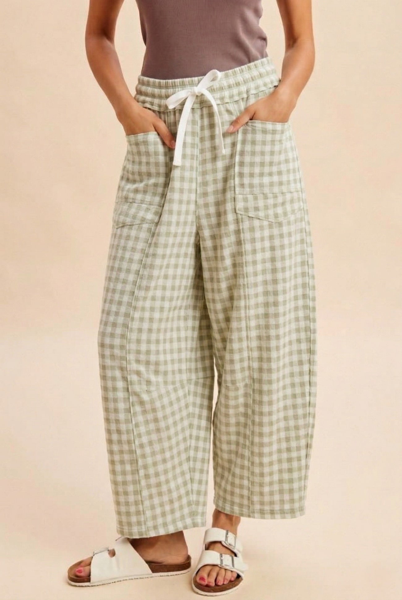 woman wearing green and white gingham wide-leg pants with a drawstring waist and pockets