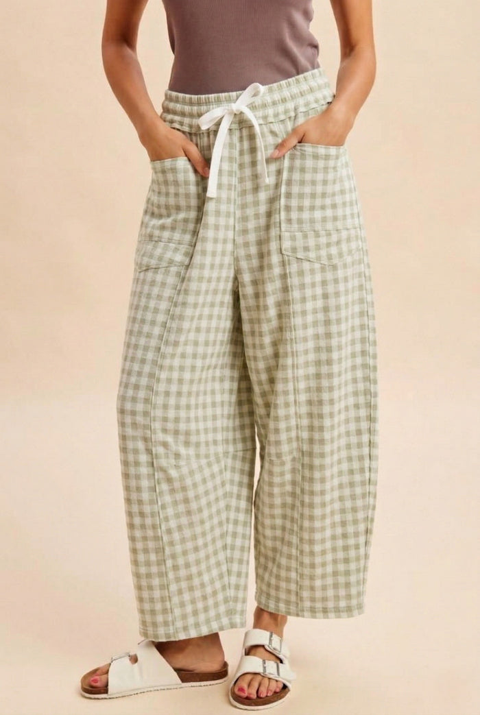 woman wearing green and white gingham wide-leg pants with a drawstring waist and pockets