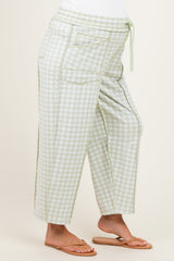 woman wearing maternity light green gingham check cropped pants with a drawstring waist and side pockets