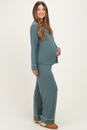 woman wearing a teal maternity pajama set with long sleeves and pants, showcasing her baby bump