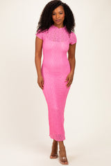 woman wearing a hot pink lace midi dress with short sleeves and a fitted silhouette