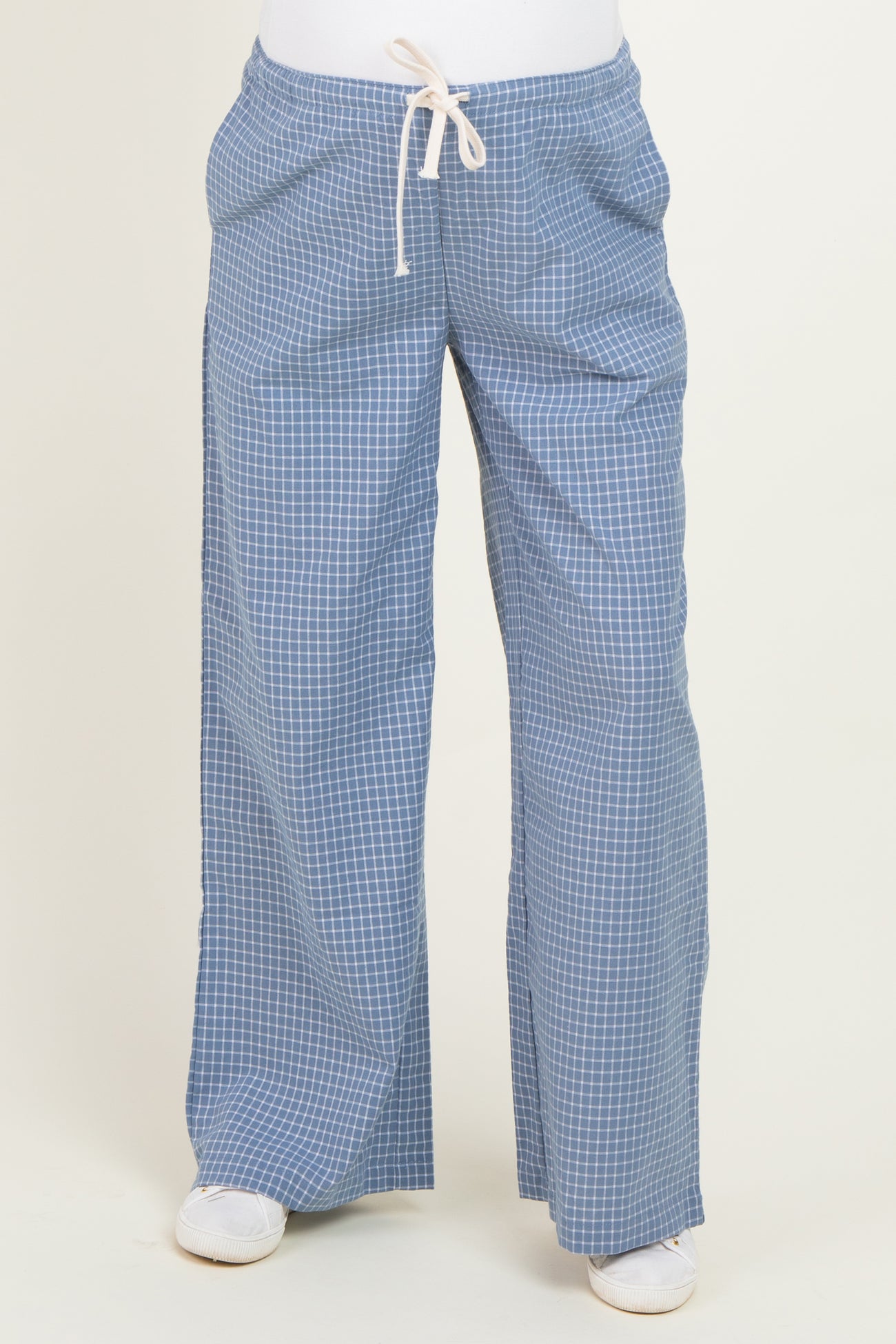 woman wearing light blue maternity plaid pants with an elastic waistband and drawstring