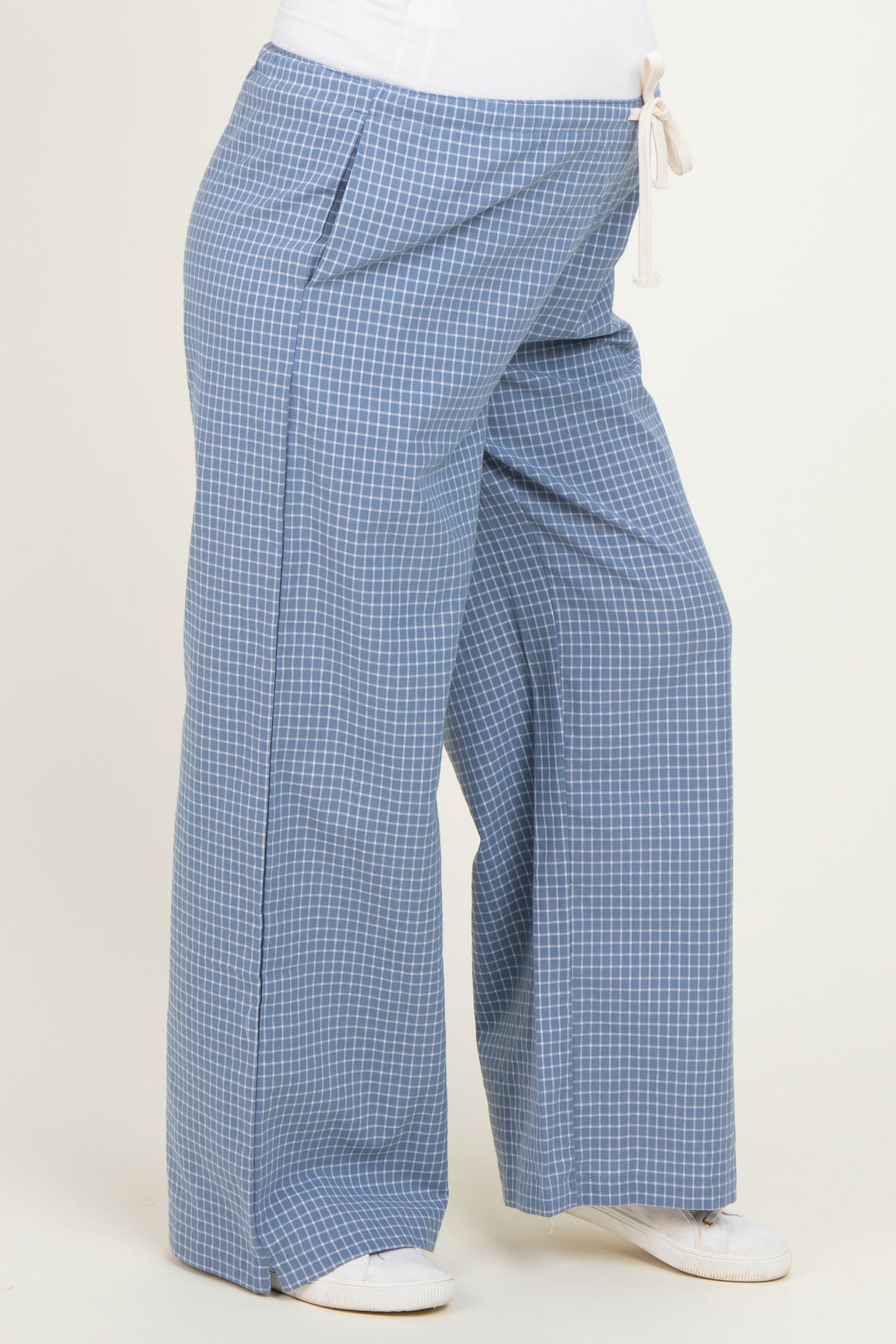 maternity wear wide-leg pants in blue gingham pattern with a drawstring waist and side pockets, worn by a model with a baby bump