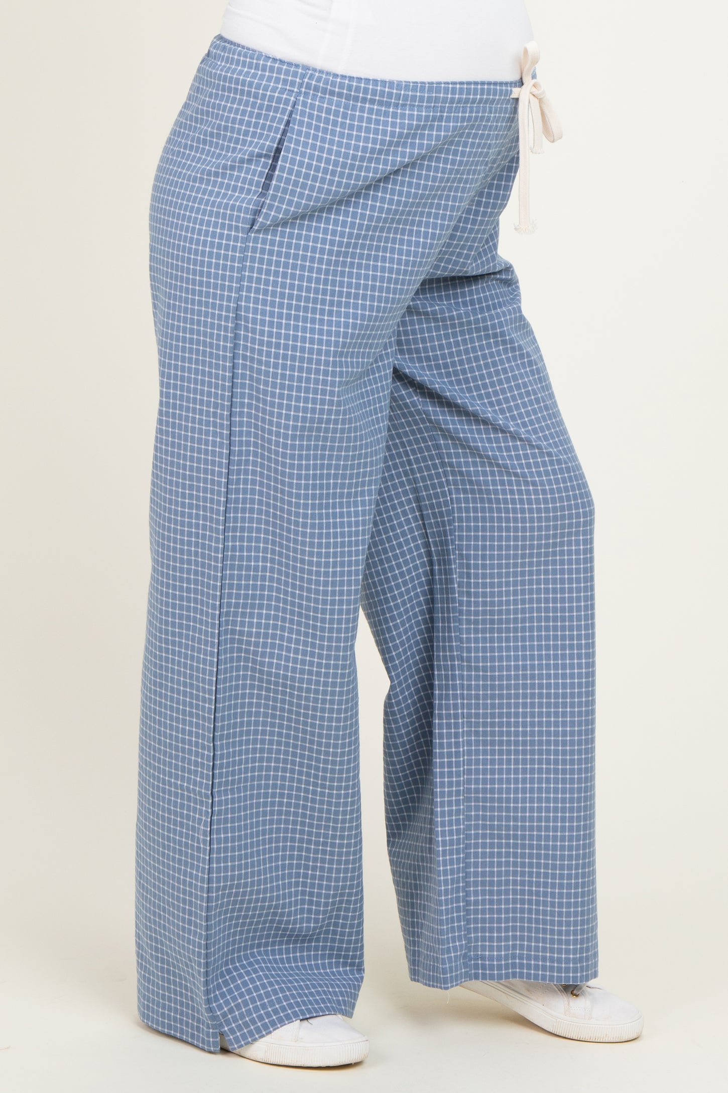 maternity wear wide-leg pants in blue gingham pattern with a drawstring waist and side pockets, worn by a model with a baby bump