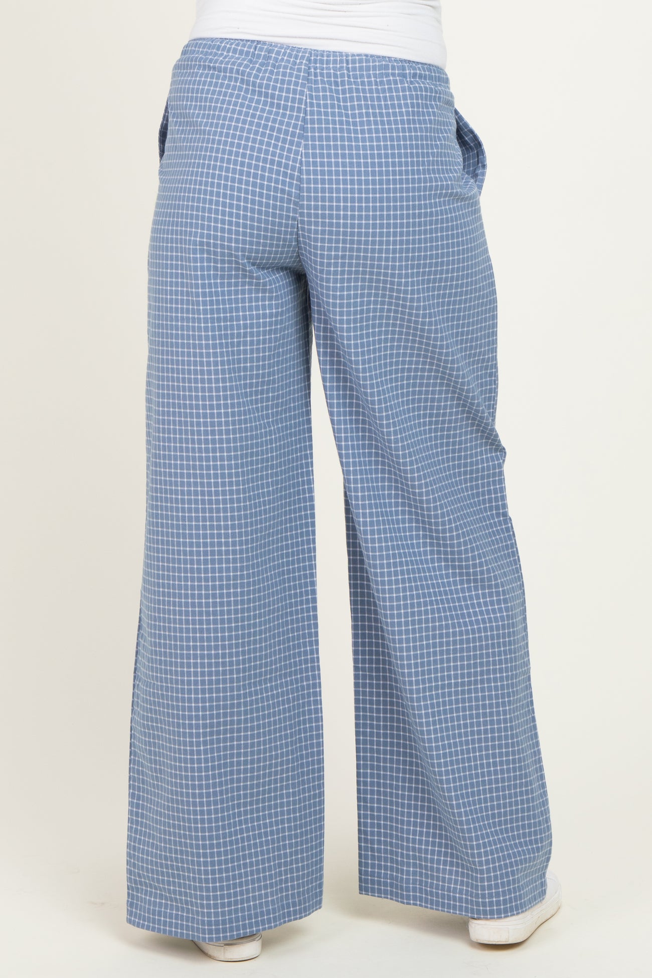 woman wearing blue checkered wide-leg maternity pants, viewed from the back
