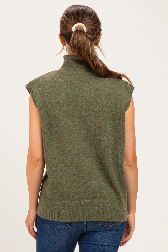 woman wearing a green sleeveless maternity sweater with a mock neck and back view, paired with blue jeans