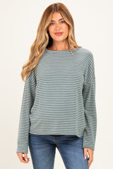 woman wearing a teal and white striped maternity top with long sleeves and relaxed fit