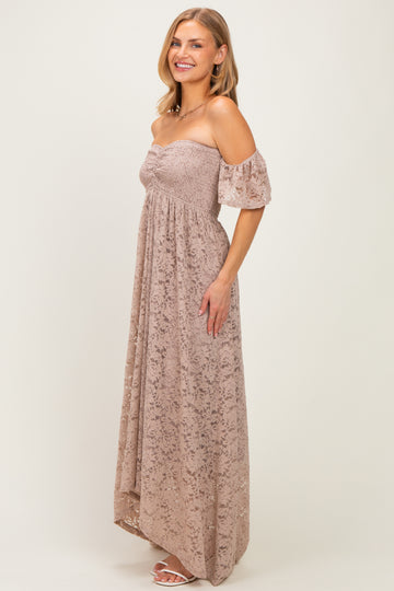 woman wearing a blush off-the-shoulder maxi dress with a smocked bodice and puff sleeves