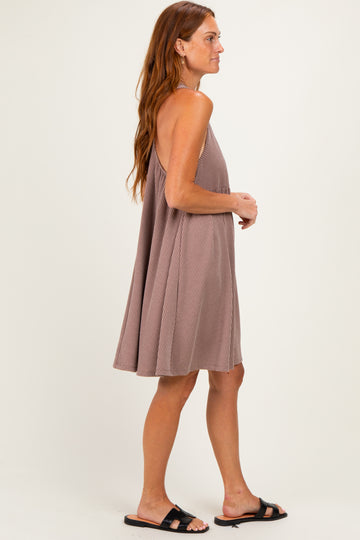 woman wearing a taupe ribbed sundress with a loose fit and thin straps