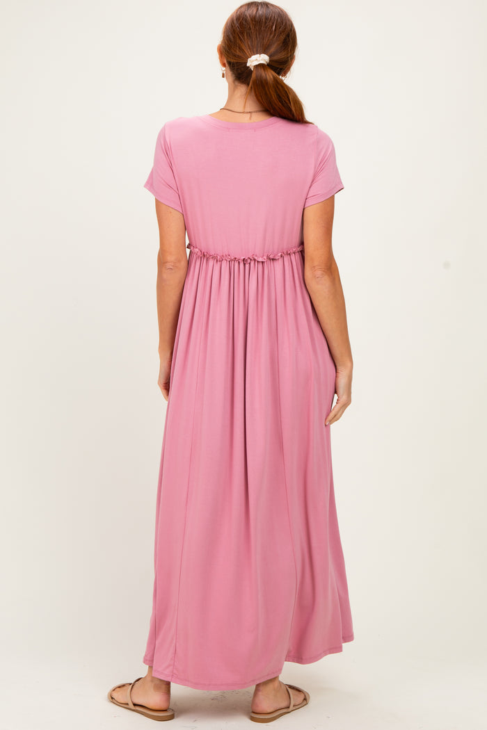 woman wearing a pink short sleeve maxi dress with an elastic waist from the back