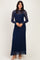 woman wearing a navy blue long sleeve lace gown with a fitted silhouette and round neckline