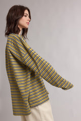 woman wearing a mustard yellow and navy striped long sleeve top with a relaxed fit