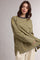 woman wearing a green and yellow striped long sleeve top with side slits and a relaxed fit