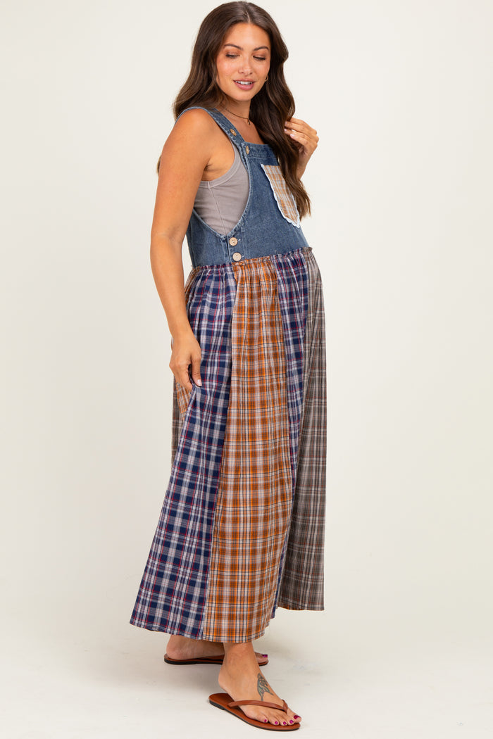 woman wearing a denim maternity maxi dress with a patchwork plaid skirt and a sleeveless top, showing her baby bump