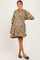 woman wearing a taupe paisley print maternity dress with a v-neck and balloon sleeves, showing her baby bump