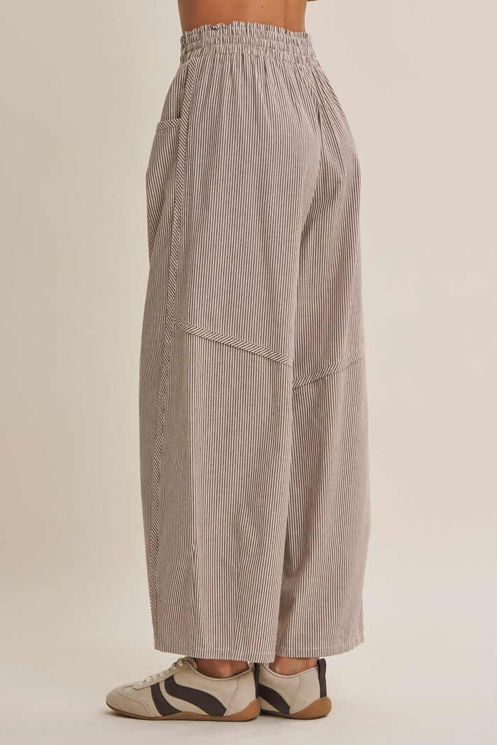 woman wearing loose-fitting striped wide-leg pants with an elastic waistband and side pockets