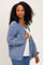 woman wearing a cozy blue oversized cardigan over a white top, styled with casual denim jeans