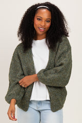 woman wearing a green oversized cardigan with balloon sleeves and a white t-shirt underneath