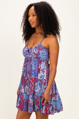 woman wearing a colorful patterned sundress with spaghetti straps and a flared silhouette