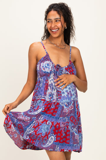 woman wearing a colorful patterned maternity dress with a tie front and a visible baby bump