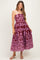 woman wearing a maroon strapless maternity dress with a purple floral print and a flowy full skirt