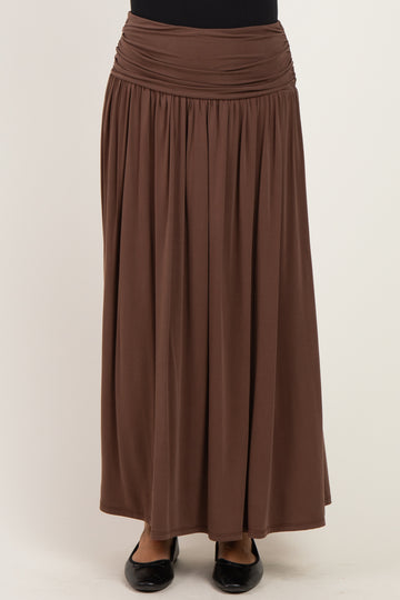 woman wearing a brown maxi skirt with a gathered waistband and flowing silhouette