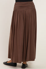 woman wearing a brown maxi skirt with gathered waist detailing, seen from the back