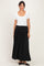woman wearing a white short sleeve top and a black maxi skirt with a gathered waistband