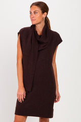 woman wearing a burgundy sleeveless dress with a scarf draped around the neck