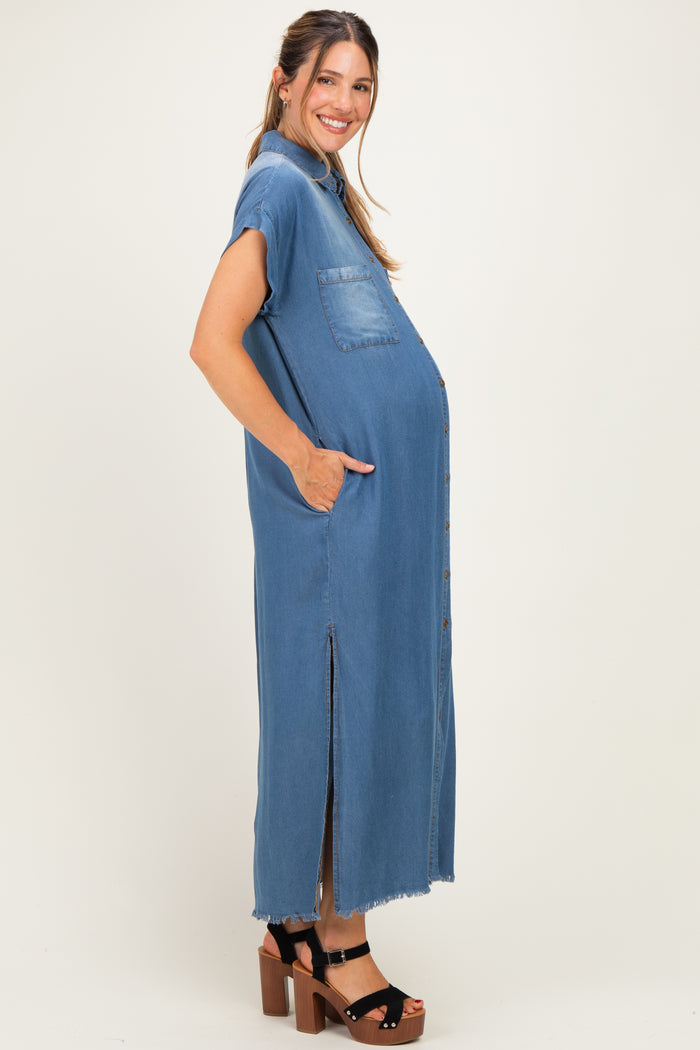 woman wearing a blue denim maternity dress with short sleeves, side pockets, and a front slit, showcasing her baby bump