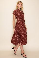 woman wearing a maroon short sleeve shirt dress with white polka dots and a tie waist detail, styled with black sandals