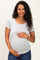 woman wearing a light grey short sleeve maternity top and holding her baby bump