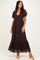 woman wearing a dark brown lace maxi dress with puff sleeves and a tiered hem