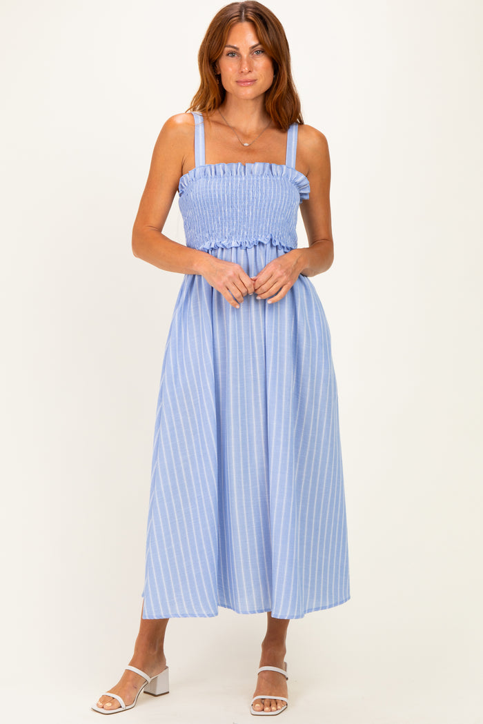 woman wearing a light blue striped maxi dress with a smocked bodice and adjustable straps