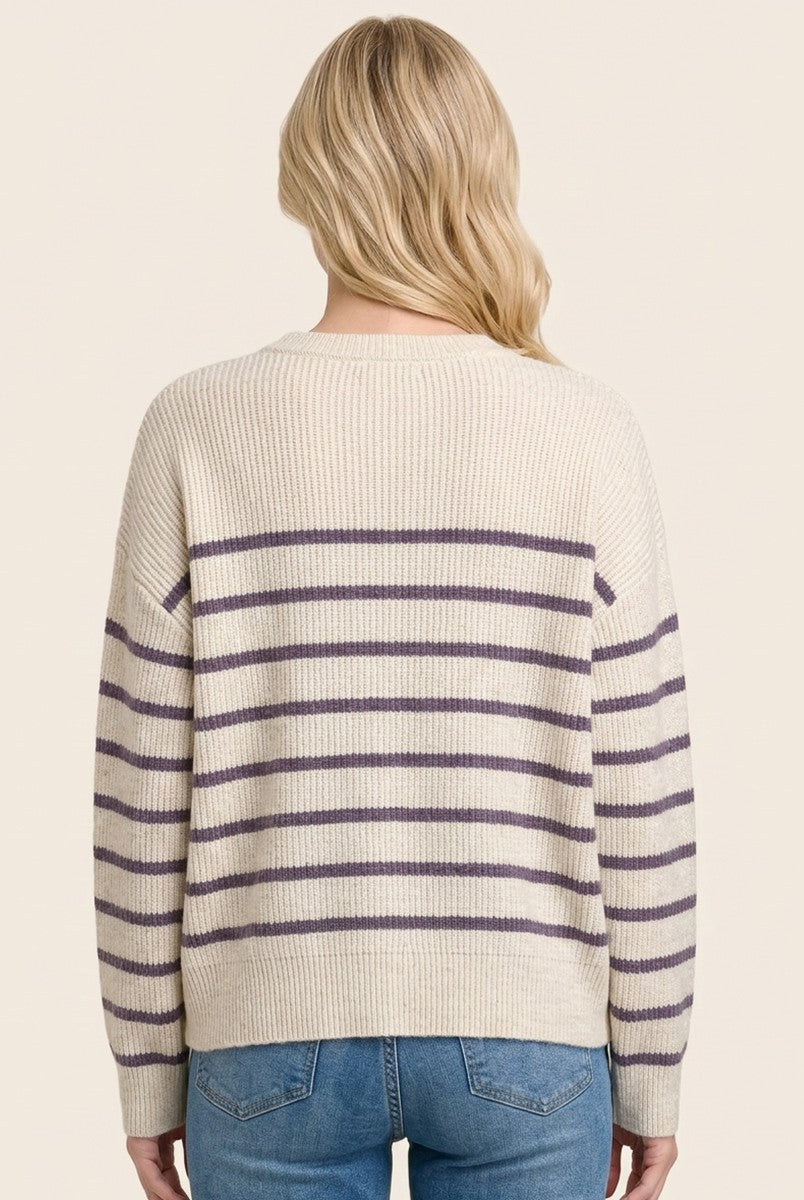 woman wearing a cream striped sweater with purple lines and a relaxed fit, shown from the back