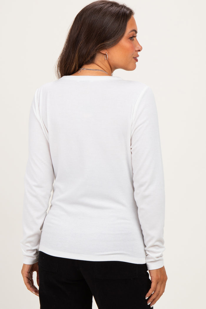 woman wearing a white long sleeve maternity top, seen from the back, with a fitted style and ribbed texture